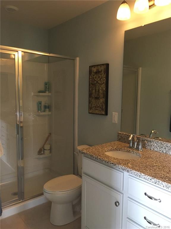 1010 Currituck Way, Unit 67 York, SC 29745 - Photo 12 of 24 a bathroom with a granite countertop sink toilet and shower