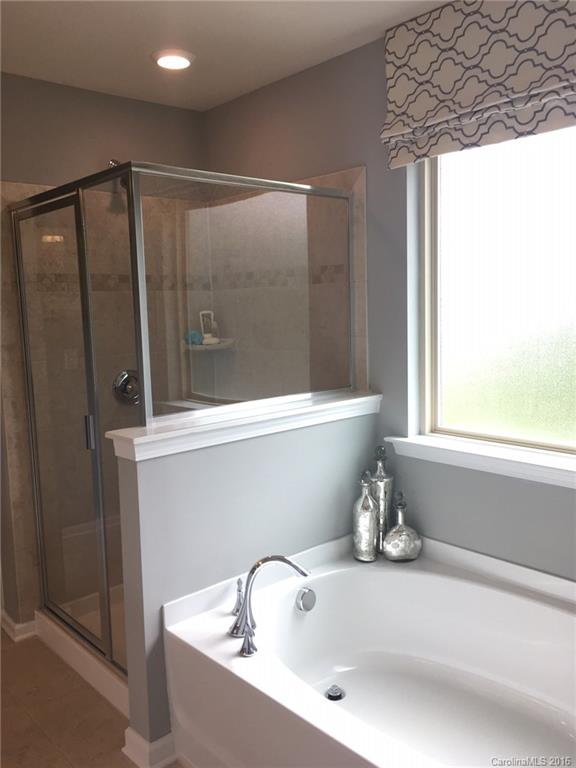 1010 Currituck Way, Unit 67 York, SC 29745 - Photo 7 of 24 a bathroom with a bathtub and a shower