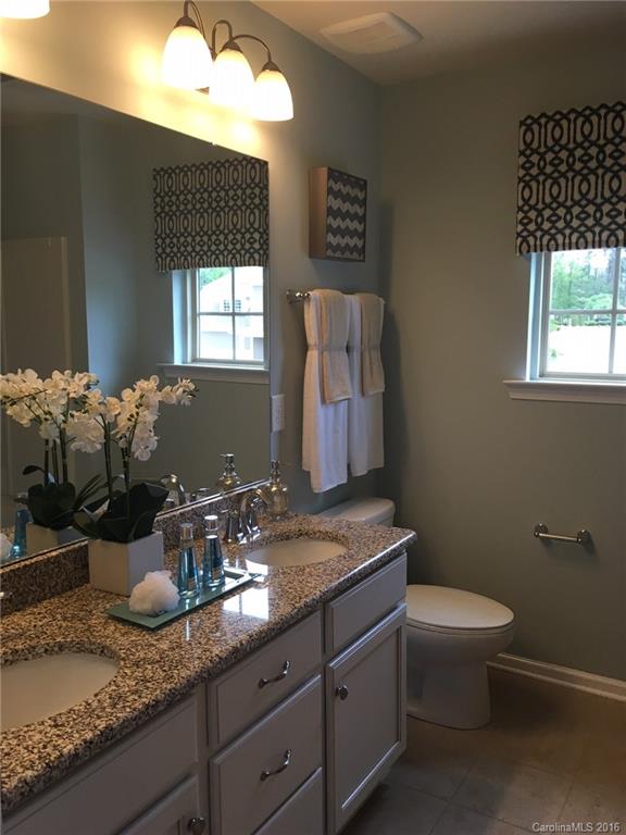 1010 Currituck Way, Unit 67 York, SC 29745 - Photo 10 of 24 a bathroom with a granite countertop sink a toilet and mirror