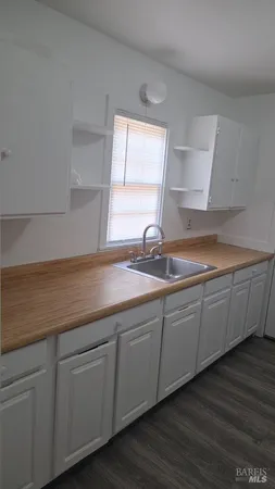 a kitchen with sink and cabinets