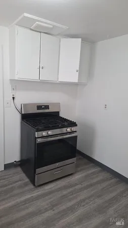 a stove top oven sitting inside of a kitchen
