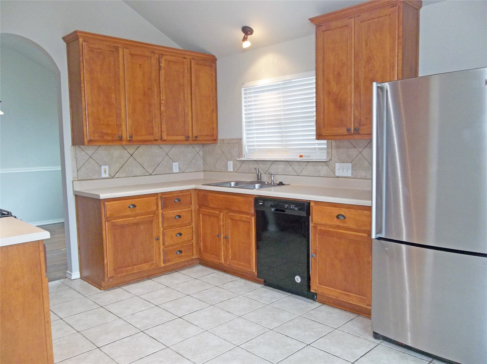 110 Fossil Trail Leander, TX 78641 - Photo 6 of 21 a kitchen with stainless steel appliances granite countertop a refrigerator sink and cabinets