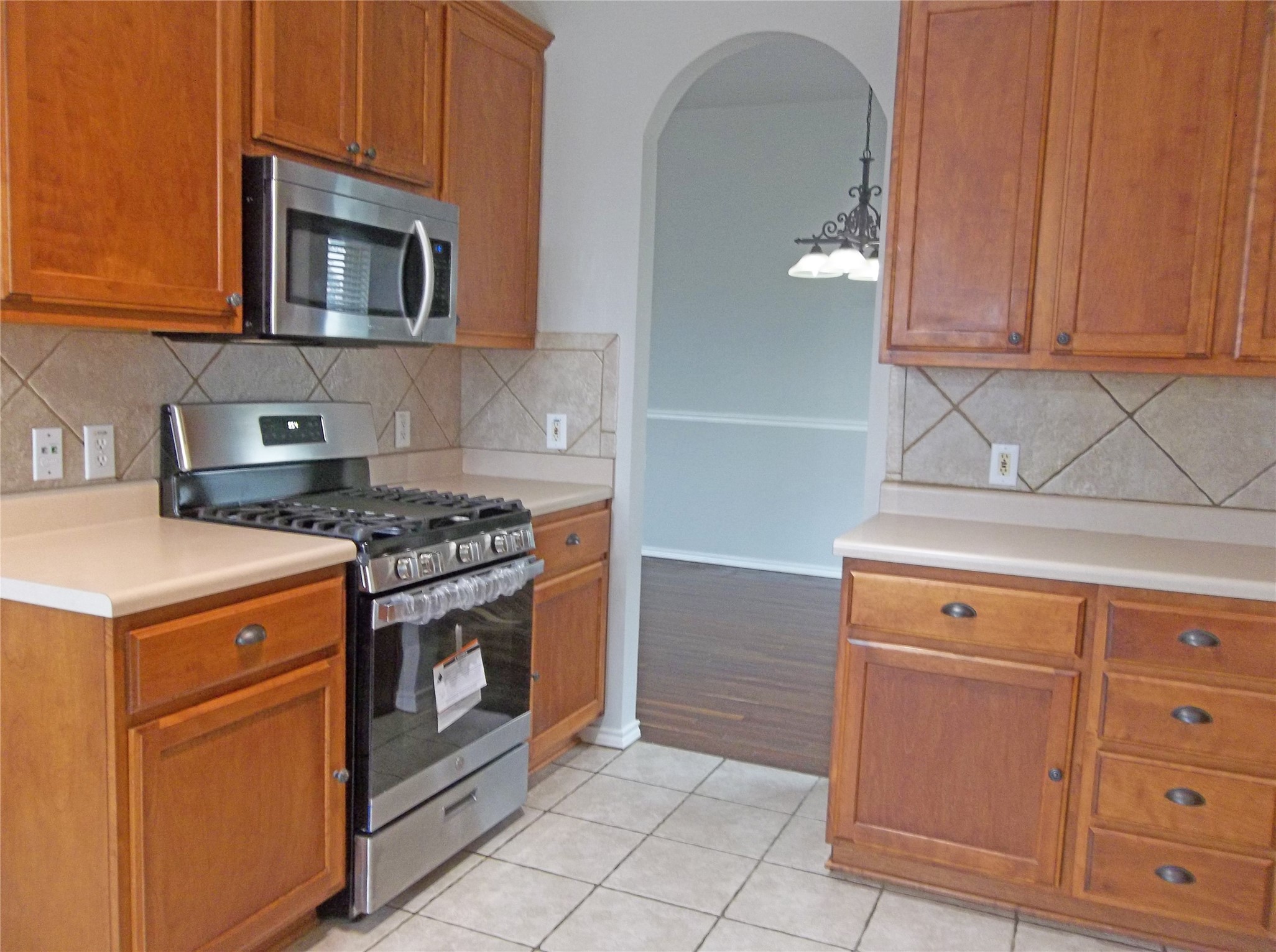 110 Fossil Trail Leander, TX 78641 - Photo 8 of 21 a kitchen with granite countertop white cabinets stainless steel appliances and sink