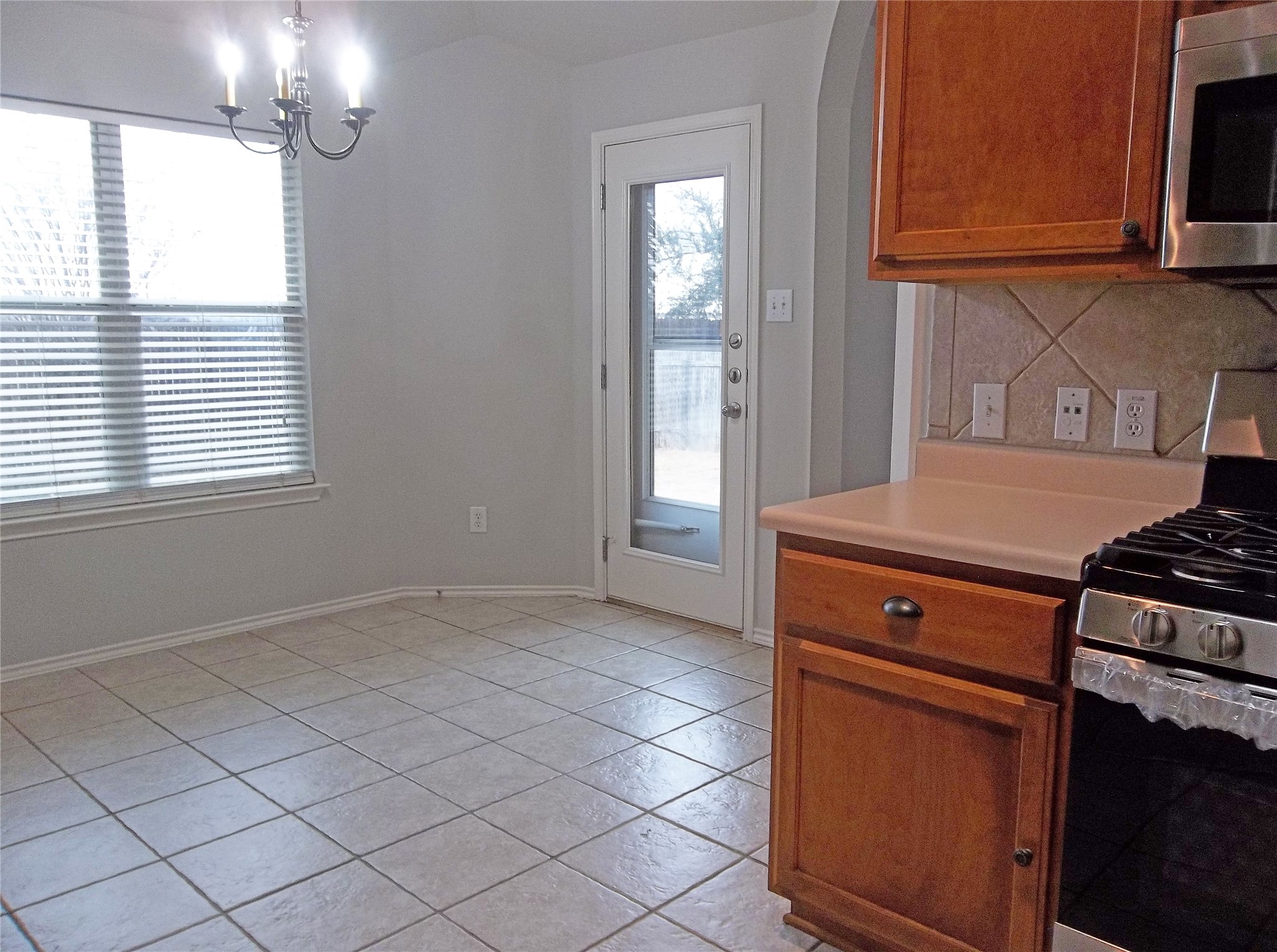110 Fossil Trail Leander, TX 78641 - Photo 10 of 21 a kitchen with a stove and a microwave