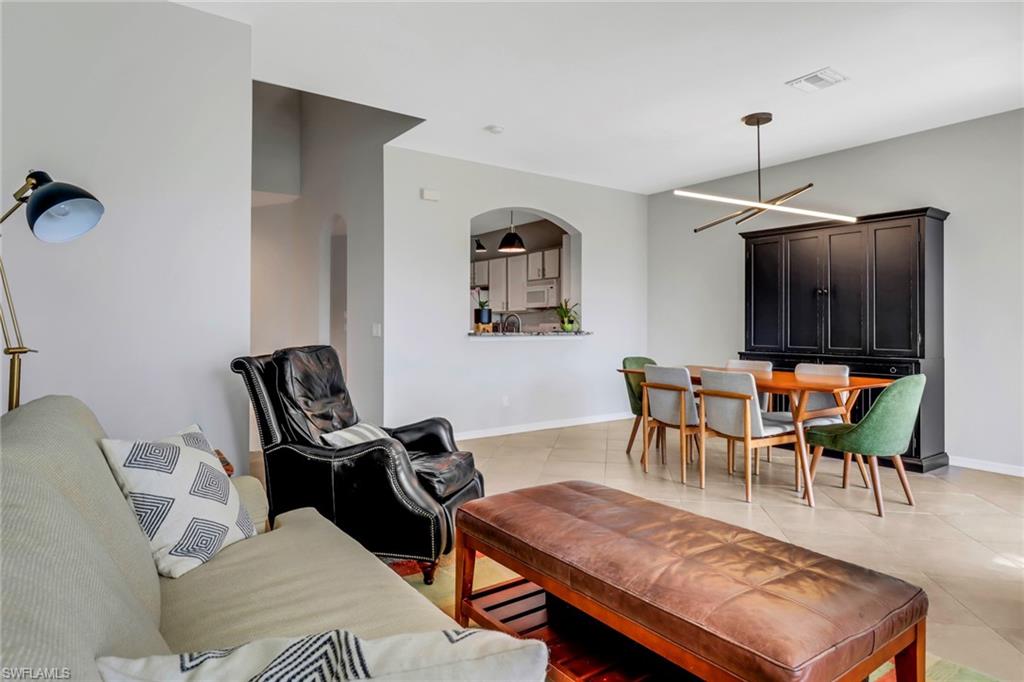 20024 Heatherstone Way, Unit 2 Estero, FL 33928 - Photo 11 of 38 a living room with furniture and a flat screen tv