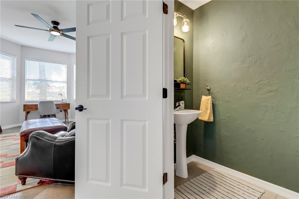 20024 Heatherstone Way, Unit 2 Estero, FL 33928 - Photo 13 of 38 a bathroom with a sink and a mirror
