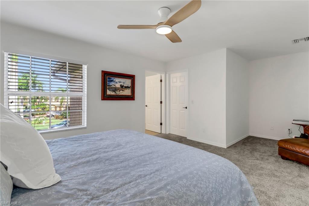 20024 Heatherstone Way, Unit 2 Estero, FL 33928 - Photo 15 of 38 a bedroom with a bed and a large window