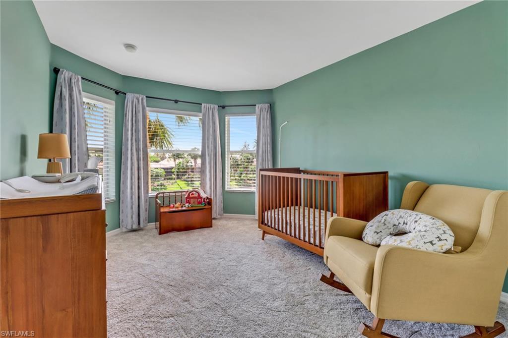 20024 Heatherstone Way, Unit 2 Estero, FL 33928 - Photo 19 of 38 a bed room with a bed and a couch