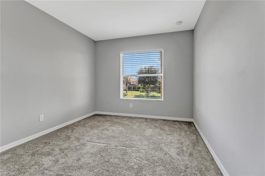 20024 Heatherstone Way, Unit 2 Estero, FL 33928 - Photo 22 of 38 an empty room with windows
