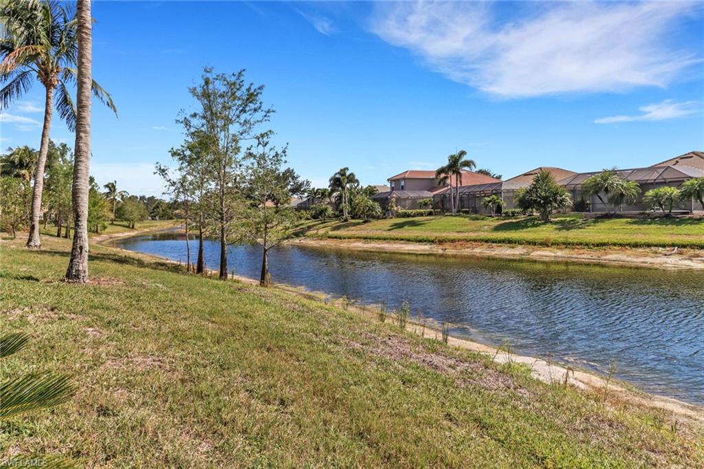 20024 Heatherstone Way, Unit 2 Estero, FL 33928 - Photo 27 of 38 a view of a lake with a mountain in the background
