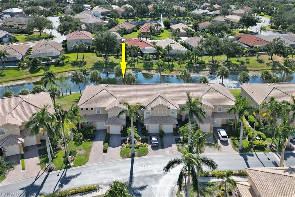 20024 Heatherstone Way, Unit 2 Estero, FL 33928 - Photo 28 of 38 an aerial view of multiple houses with yard