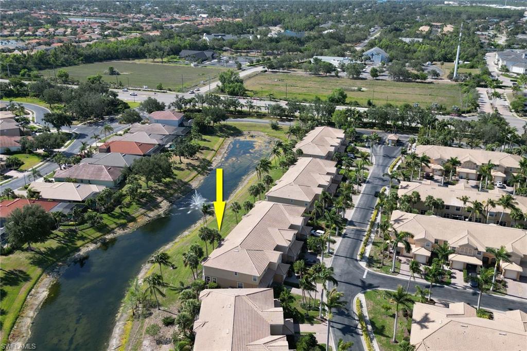 20024 Heatherstone Way, Unit 2 Estero, FL 33928 - Photo 30 of 38 an aerial view of city lake and trees all around
