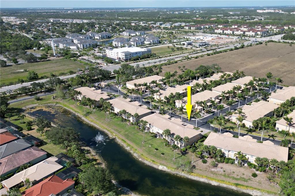 20024 Heatherstone Way, Unit 2 Estero, FL 33928 - Photo 31 of 38 an aerial view of city and lake with trees