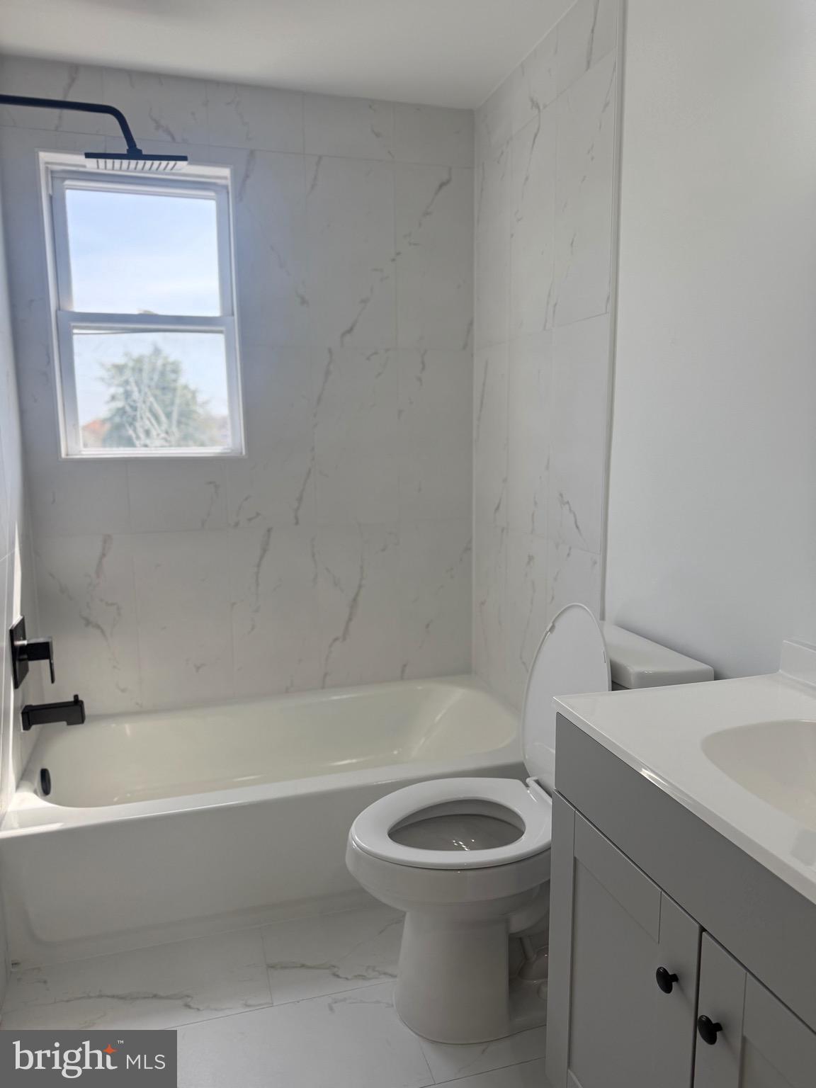 2125 Oakland Road Middle River, MD 21220 - Photo 14 of 15 a bathroom with a toilet a sink and bathtub