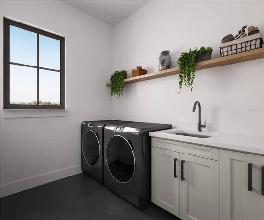 a utility room with sink dryer and washer
