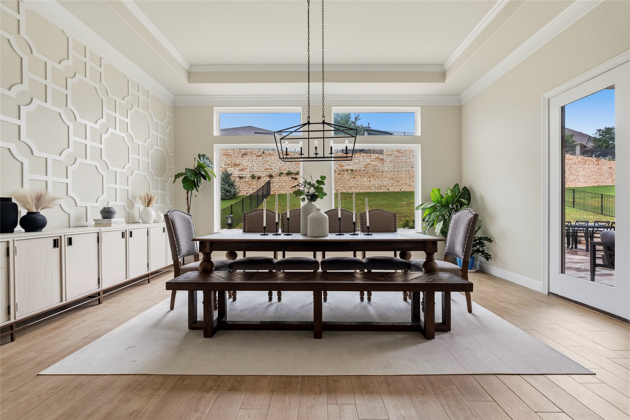 4513 Vieste View Leander, TX 78641 - Photo 20 of 40 Spacious dining area featuring a tray ceiling, decorative wall decor, and wood-finish flooring