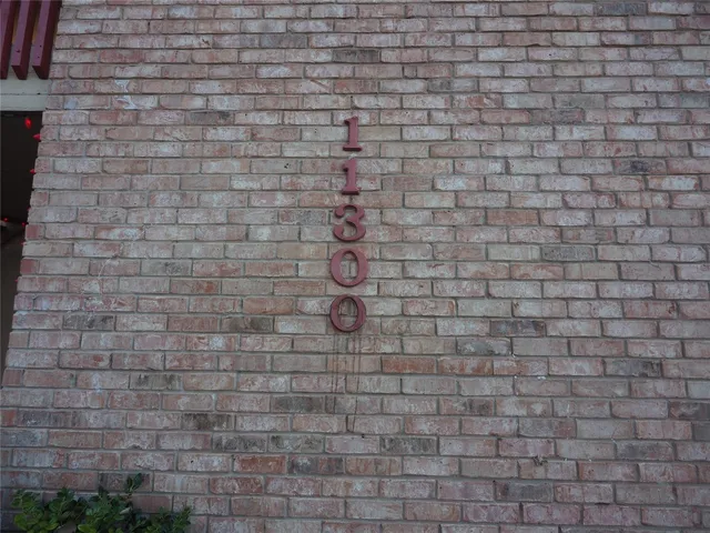 a brick wall with a white wall