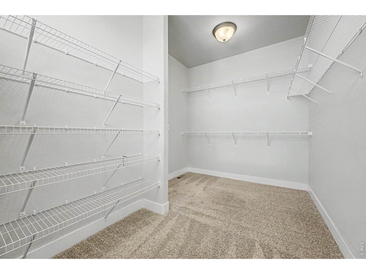 2069 Day Spring Drive Windsor, CO 80550 - Photo 17 of 47 Generous primary closet designed for everyday functionality