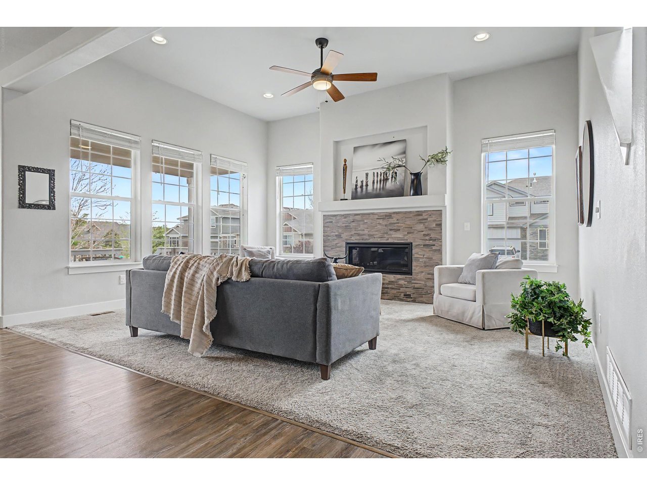 2069 Day Spring Drive Windsor, CO 80550 - Photo 3 of 47 Comfortable living space centered around a warm gas fireplace, flooded with natural light and added architectural detail.