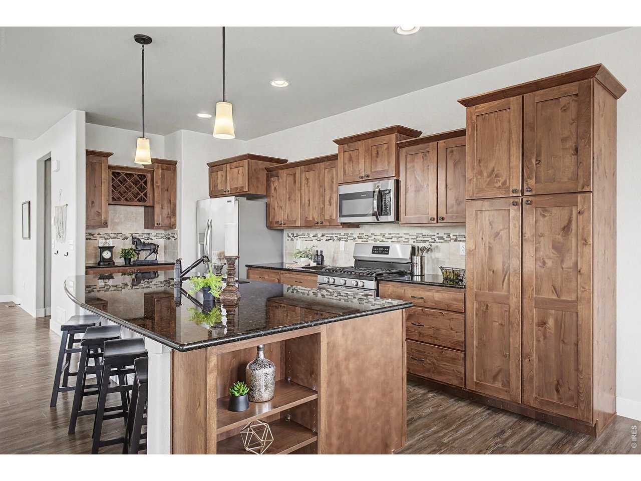 2069 Day Spring Drive Windsor, CO 80550 - Photo 6 of 47 Spacious kitchen with functional layout for everyday living with upgraded features including a dedicated coffee bar, wine storage and inset cabinetry shelving.