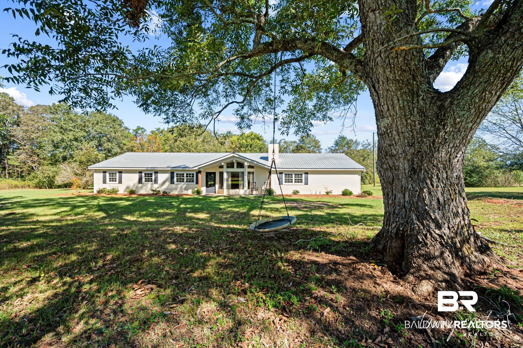 3086 Wild Fork Road Frisco City, AL 36445 - Photo 1 of 30 Rear view of property with a lawn and a metal roof