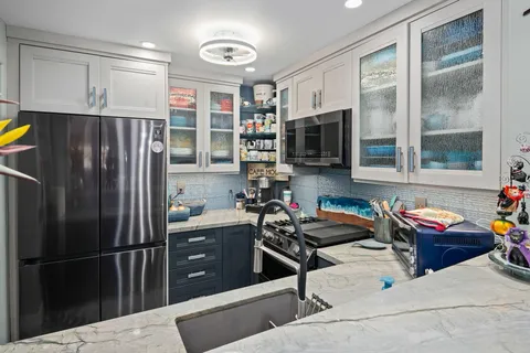 a kitchen with stove and cabinets