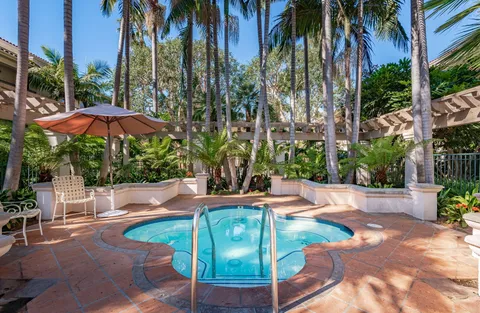 a living room with furniture kitchen view and a large window