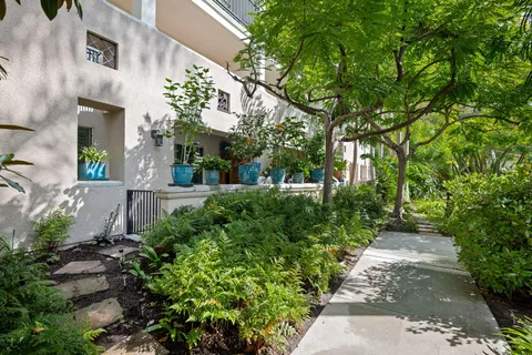 a view of a patio with furniture and garden