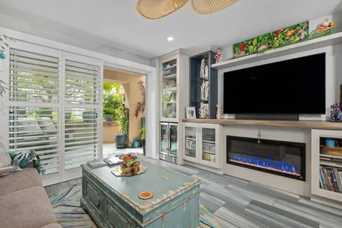 a living room with lots of furniture and kitchen view