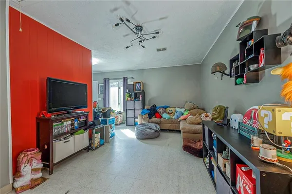a children room with toys and a flat screen tv
