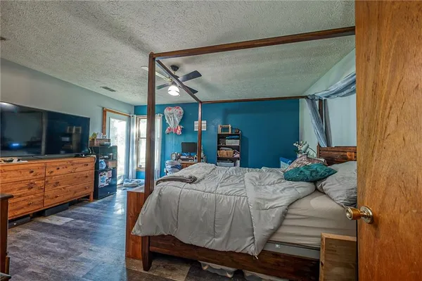 a bed room with furniture and a flat screen tv