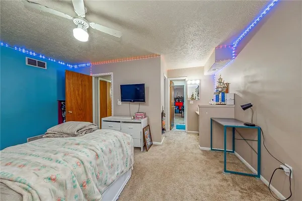 a bedroom with a bed window and a flat screen tv