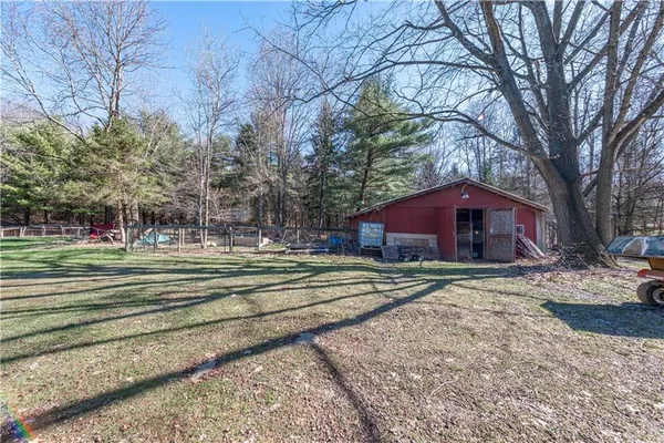 a view of a house with a yard covered in snow