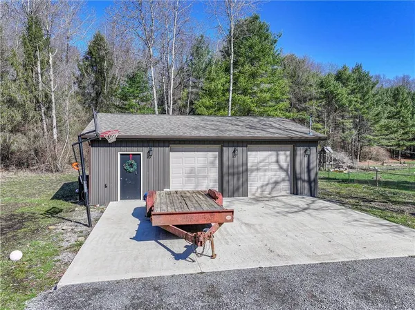a backyard of a house with table and chairs