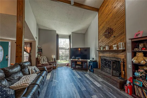 a living room with furniture a fireplace and a flat screen tv