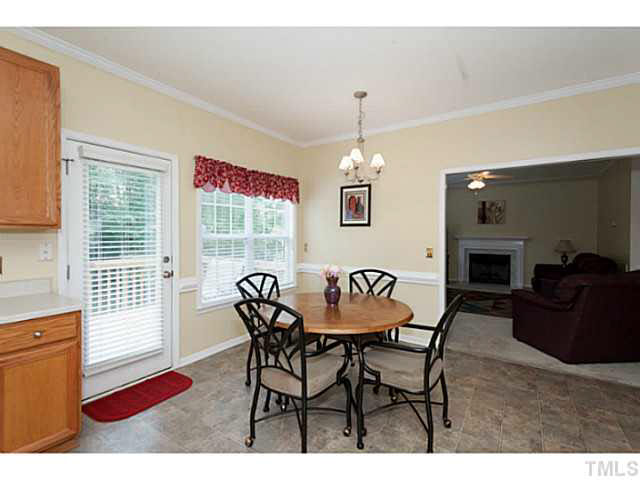 8424 Ridgebury Road Raleigh, NC 27603 - Photo 11 of 25 a view of a dining room with furniture and a chandelier