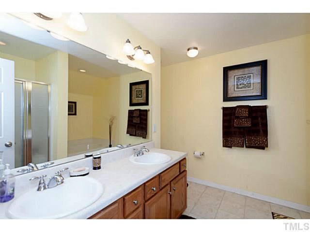 8424 Ridgebury Road Raleigh, NC 27603 - Photo 17 of 25 a bathroom with a sink vanity and a mirror