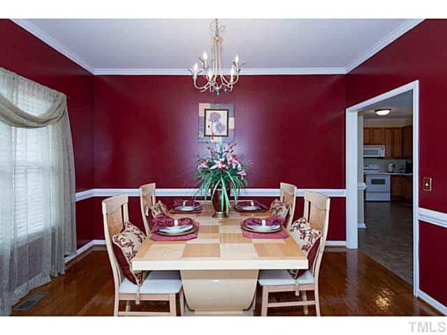 8424 Ridgebury Road Raleigh, NC 27603 - Photo 5 of 25 a view of a dining room with furniture wooden floor and chandelier