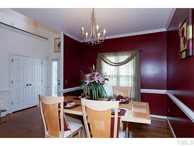 8424 Ridgebury Road Raleigh, NC 27603 - Photo 6 of 25 a view of a dining room with furniture and chandelier