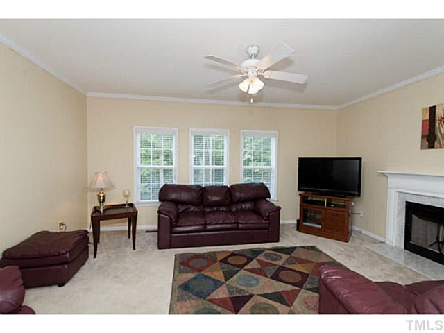 8424 Ridgebury Road Raleigh, NC 27603 - Photo 8 of 25 a living room with furniture and a flat screen tv
