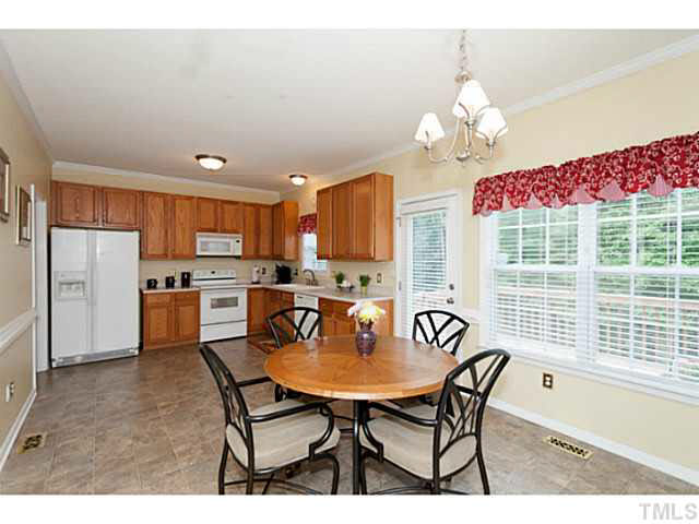 8424 Ridgebury Road Raleigh, NC 27603 - Photo 10 of 25 a dining room filled chandelier and wooden floor