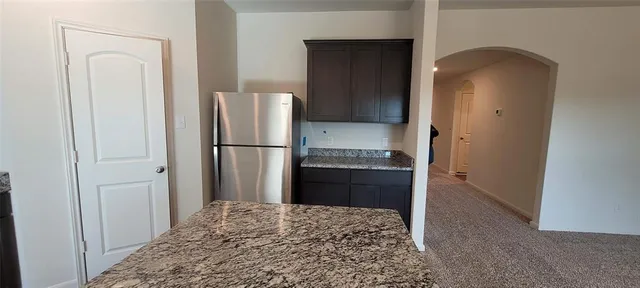 a kitchen with a refrigerator and a sink