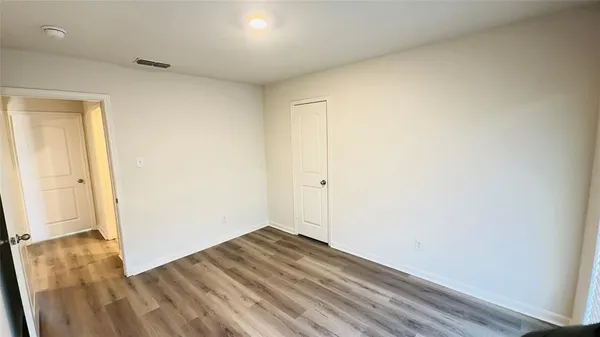 an empty room with wooden floor
