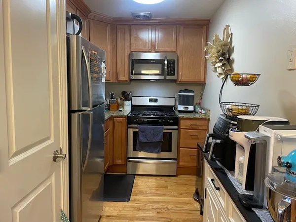 a kitchen with a sink stainless steel appliances and cabinets