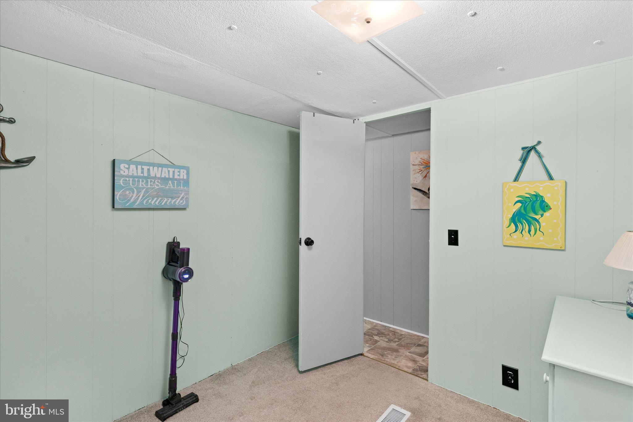38215 Possum Road Ocean View, DE 19970 - Photo 20 of 26 a view of a hallway with paintings on the wall
