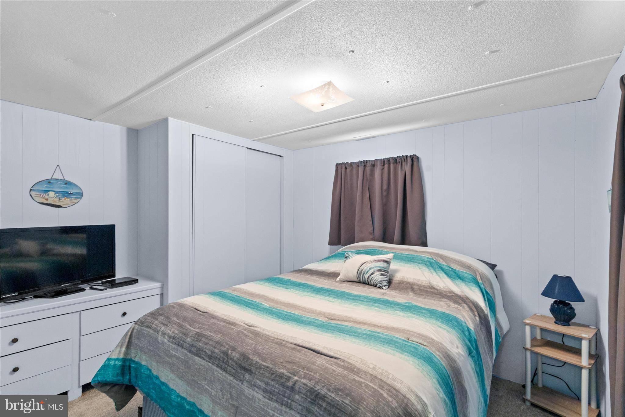 38215 Possum Road Ocean View, DE 19970 - Photo 22 of 26 a bedroom with a bed and a flat screen tv