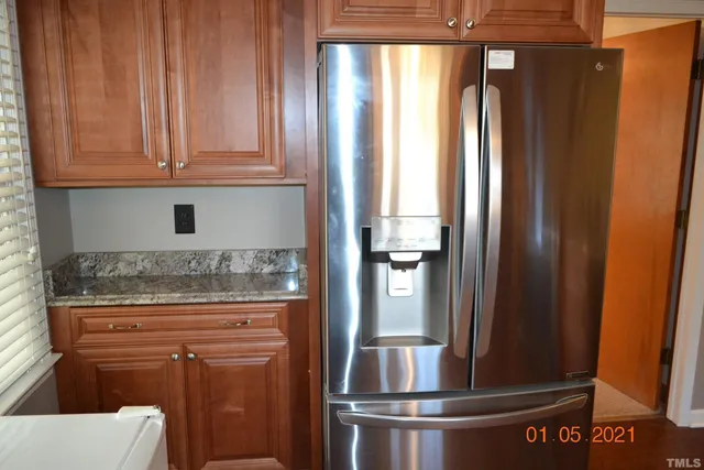 a kitchen with granite countertop stainless steel appliances and cabinets