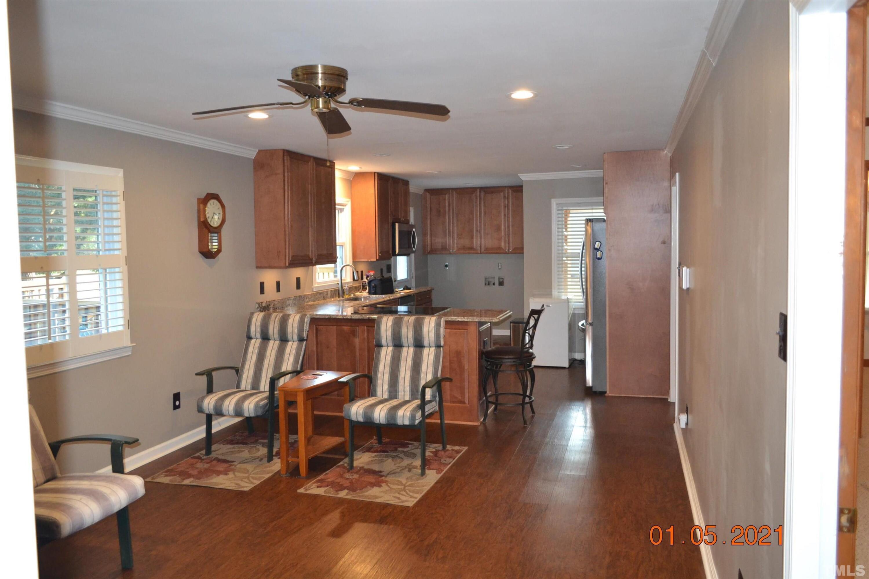 2015 Piney Plains Road Cary, NC 27518 - Photo 22 of 27 a view of a a dining room with furniture window and wooden floor