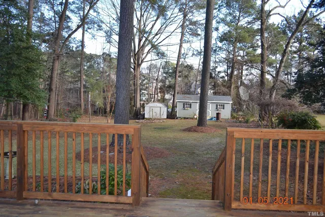 a view of a house with a wooden fence