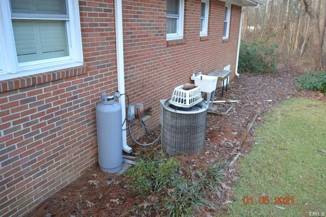 a view of a backyard with table and chairs and a barbeque